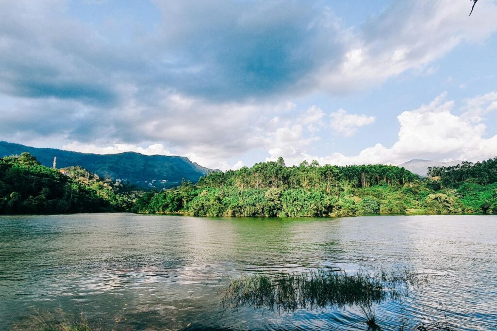Scenic lake view during daytime in Anachal Kerala surrounded by hills