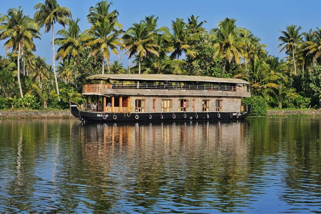 Houseboat cruising through Kumarakom backwaters Kerala